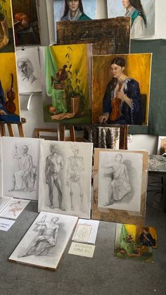 several paintings and drawings on display in an art studio with easels, canvass and other artwork