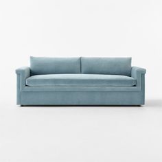 a blue couch sitting on top of a white floor