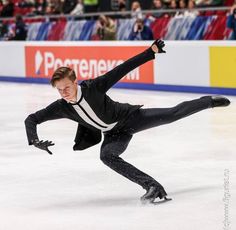 a male figure skating on an ice rink