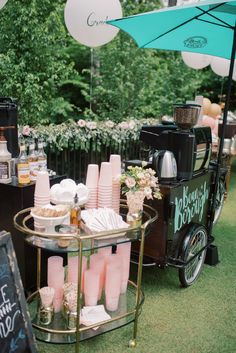 a cart with drinks and desserts on it