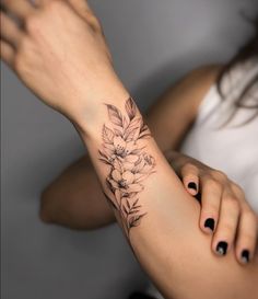 a woman with a flower tattoo on her arm