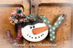 a snowman ornament hanging on a wooden door