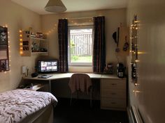 a bedroom with a bed, desk and window