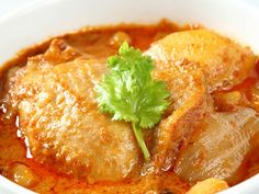 a close up of a bowl of food with meat