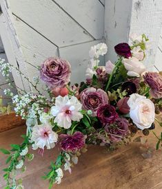 a bouquet of flowers sitting on top of a wooden table