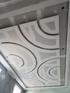 the ceiling is painted white and has circular designs on it, along with an electrical outlet