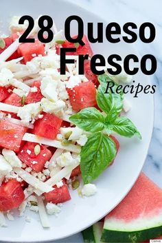 a white plate topped with watermelon and feta cheese