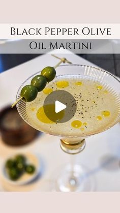 black pepper olive oil martini in a glass with an olive garnish on the rim