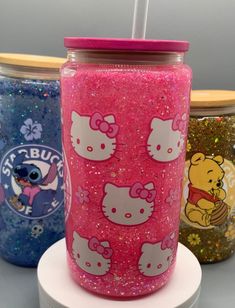 three hello kitty tumblers sitting on top of each other