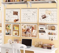 a desk with a laptop computer on top of it next to a book shelf filled with books