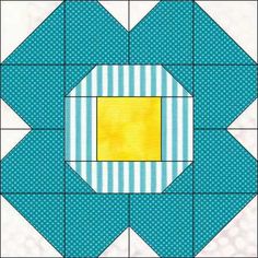 a blue and white quilt with a yellow square