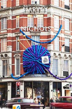 a large blue ball of yarn on top of a building