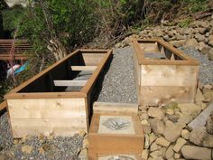 several wooden planters sitting on top of rocks