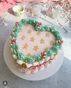 a heart shaped cake on top of a white plate next to other items and decorations