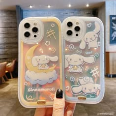 someone holding up their phone case in front of the camera with an image of two sheeps on it