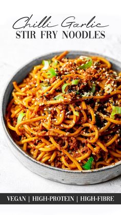 a bowl filled with stir fry noodles on top of a table