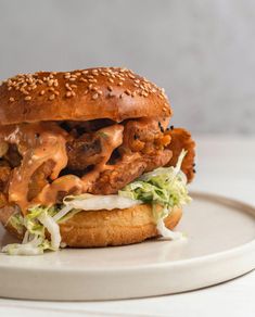 a sandwich with meat, lettuce and sauce on it