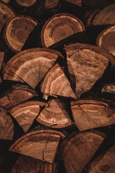 wood logs stacked on top of each other in a pile, with the tops cut off