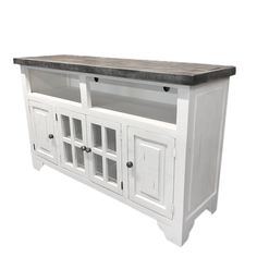 a white entertainment center with two doors and drawers on one side, black granite top