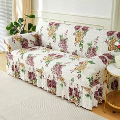 a living room with a couch covered in floral fabric