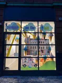 a store front window with an ice cream shop on the side and cars in the reflection