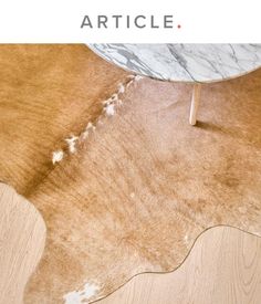 a cow hide rug is shown with the words article written below it in white letters