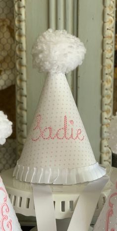 a party hat with the word babe on it sitting on top of a white table