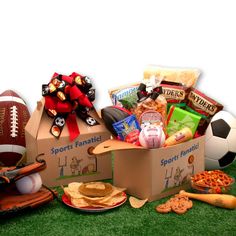 a football themed gift box filled with snacks and sports items sits on the green grass