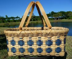 a basket sitting on top of a metal stand in front of a body of water