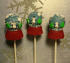 three cake pops decorated with snowmen on them