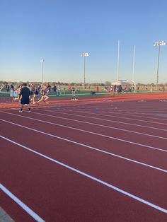 people are standing on the starting line of a running track