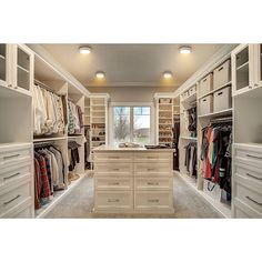 a walk in closet filled with lots of white drawers