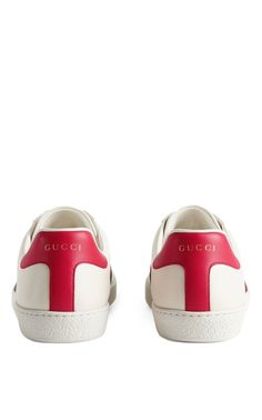 Low-top buffed leather sneakers in off-white. Round toe. Tonal lace-up closure. Padded collar. Logo printed in gold-tone at red buffed leather heel tab. Signature webbing stripes in red and green at sides. Graphic embroidered at outer side. Textured rubber midsole. Treaded rubber outsole. Tonal hardware. Supplier color: WhiteUpper: leatherSole: rubberMade in Italy Gucci Luxury Sneakers With Contrast Sole, Red Sole Low-top Calf Leather Sneakers, Low-top Calf Leather Sneakers With Red Sole, Luxury Sneakers With Rubber Heel Cap And Round Toe, Gucci Leather Sneakers With Contrast Sole, Calf Leather Sneakers With Red Sole, White Gucci Sneakers In Calf Leather, Gucci Lace-up Calf Leather Sneakers, White Gucci Calf Leather Sneakers