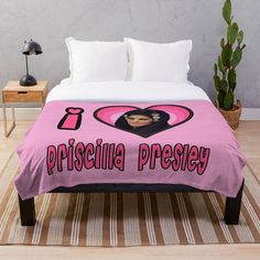 a bed with a pink blanket that says,'princessa preseyy '