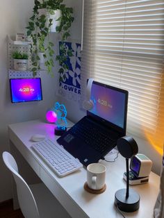 a laptop computer sitting on top of a white desk