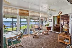 a living room filled with furniture and lots of windows