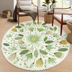 a round rug with leaves on it in a living room next to two chairs and a potted plant