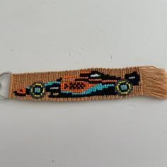 an embroidered key chain with a car on it