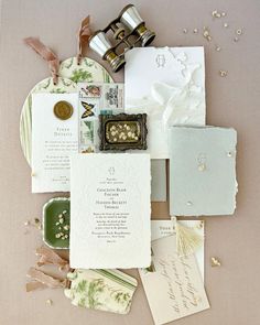 the wedding stationery is laid out on top of each other