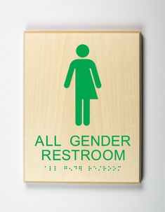 an all gender restroom sign mounted on a wall