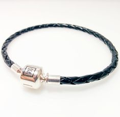 Single strand and double strand black leather bracelet with silver barrel clasp Black and stylish genuine leather bracelet will be an excellent decoration for your wrist by itself or with any of our charms and beads! Materials: 925 Sterling silver, genuine leather Weight: 5.0g Every bracelet comes with a free pouch. Black Leather Bracelet With Sterling Silver Clasp, Adjustable Black Leather Rocker Bracelet, Adjustable Black Leather Bracelet With Lobster Clasp, Pandora Style Bracelet, Adjustable Nickel-free Black Leather Bracelet, Black Leather Braided Bracelet With Stainless Steel Clasp, Genuine Leather Bracelet, Bracelet Pandora, Black Leather Bracelet