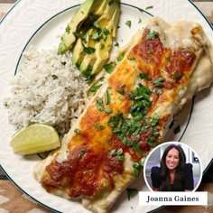 a white plate topped with fish and rice next to a slice of avocado