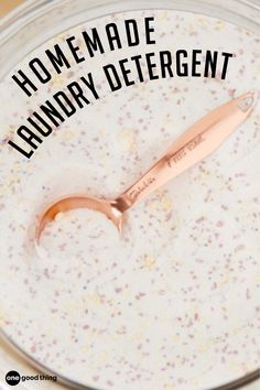 a close up of a spoon in a bowl with liquid and text that reads homemade laundry deterant