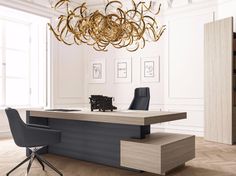 an office with a desk, chair and chandelier