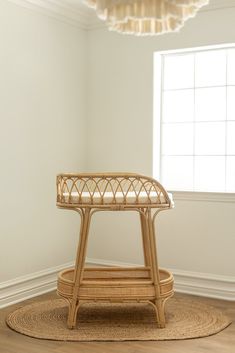 a wicker stool sits in the corner of a room with a round rug on the floor