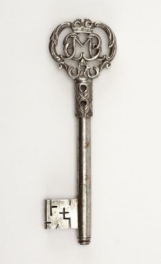 an antique key with the letter d on it