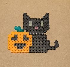 a cat made out of legos sitting next to each other on the ground,