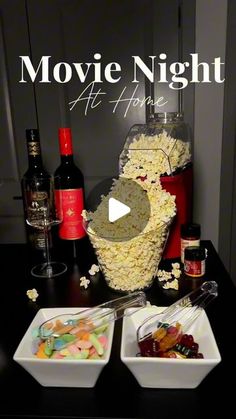 a table topped with two bowls filled with food and wine bottles next to each other