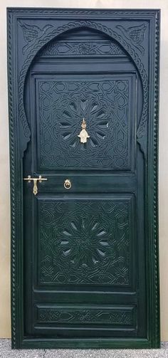 a black door with an intricate design on the front and side doors, which are painted green