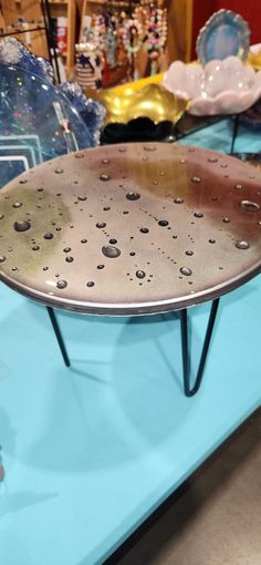 Moon table that is 16 in high with pin legs. Shimmery silver and gold metallic gold. Waterdrip effect. Moon Table, Pin Legs, Mini Moon, Water Drops, Metallic Gold, Home Accents, Gold Metal, Moon, Home And Living